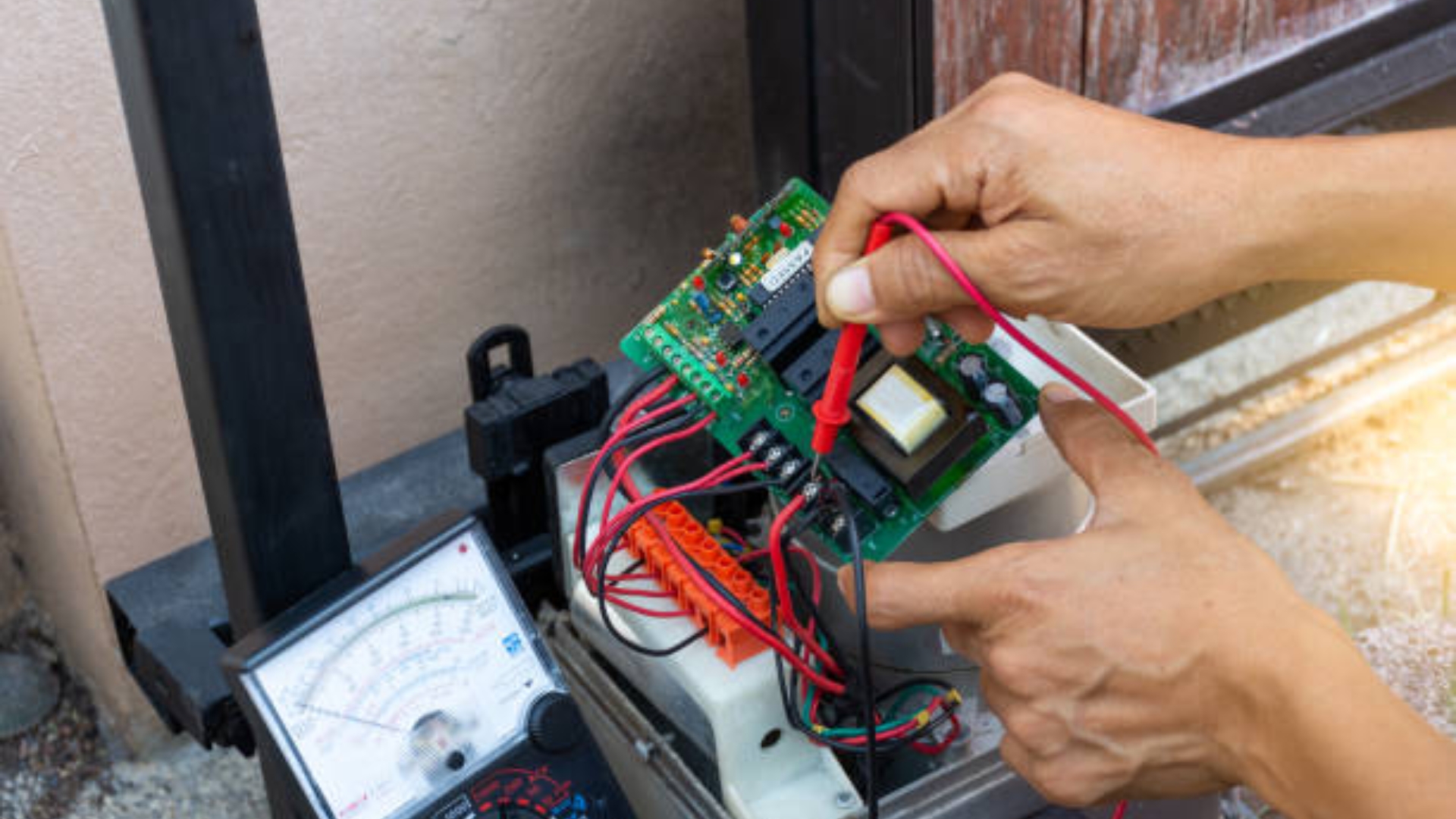 A technician testing the wiring of a garage door keypad