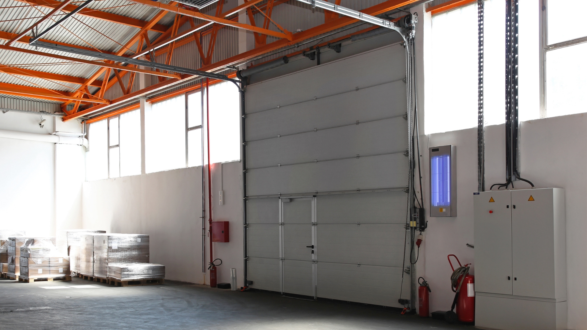 A commercial garage door with industrial torsion springs