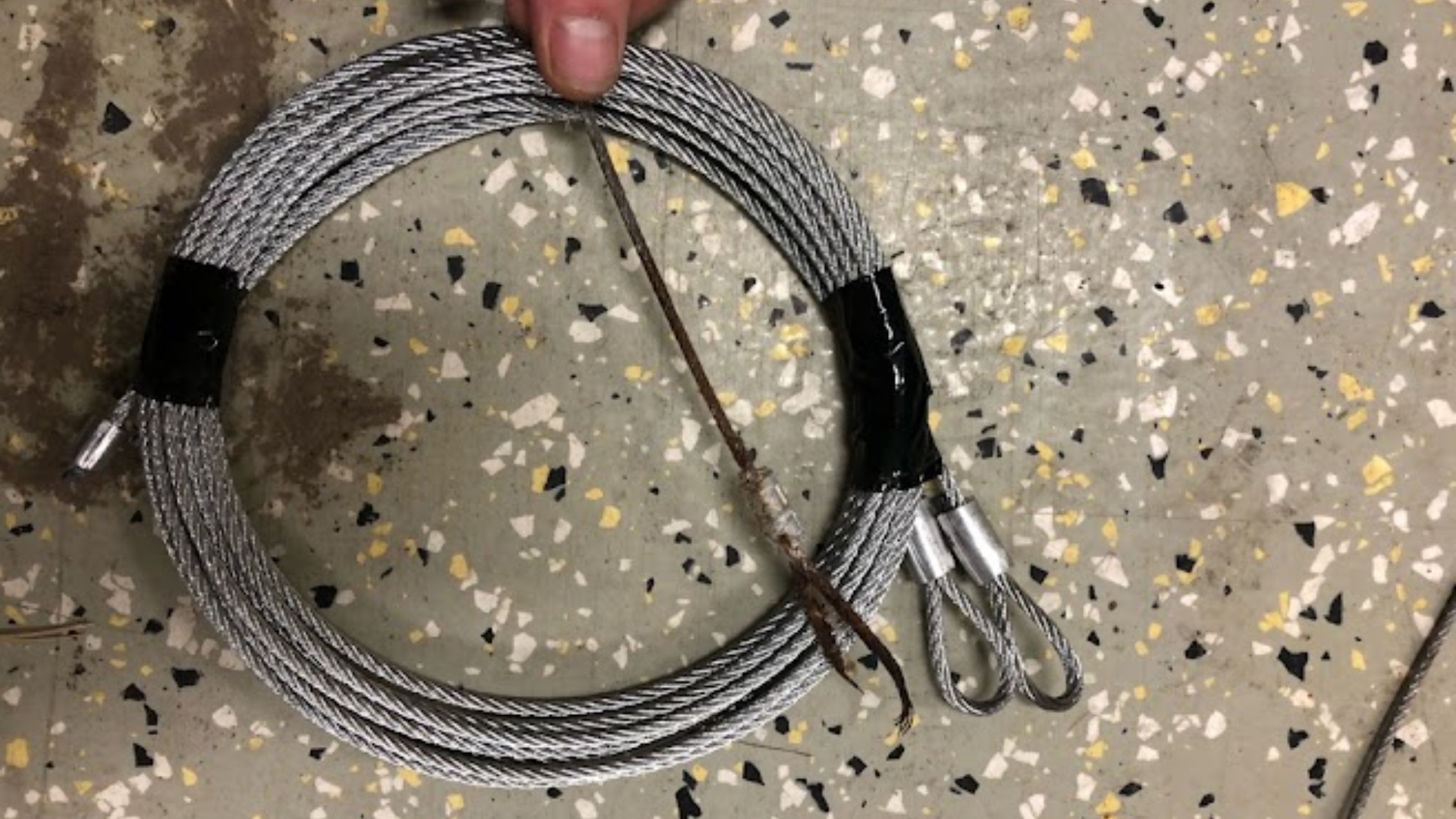 A broken garage door cable due to corrosion