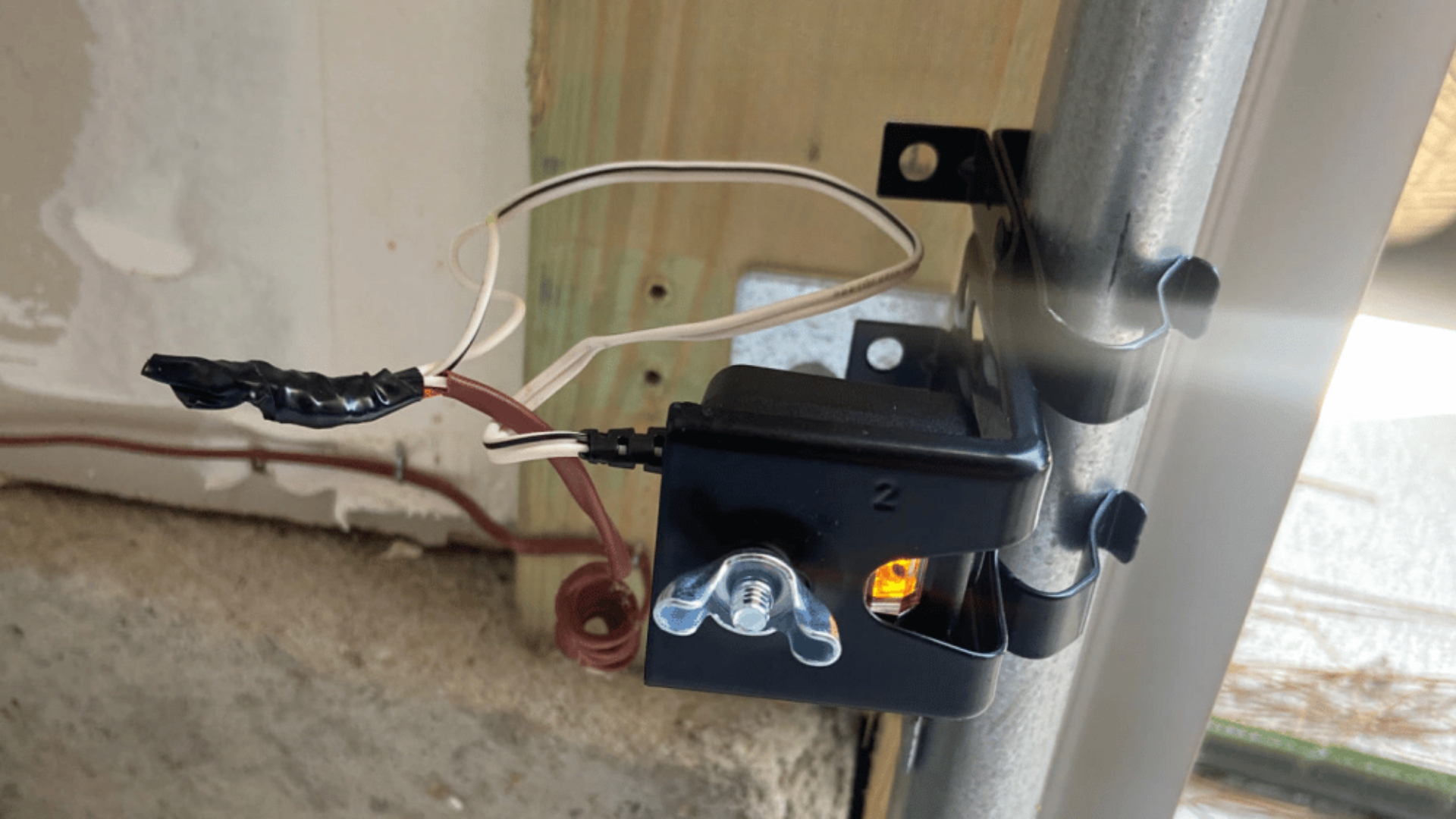 A newly installed garage door sensor
