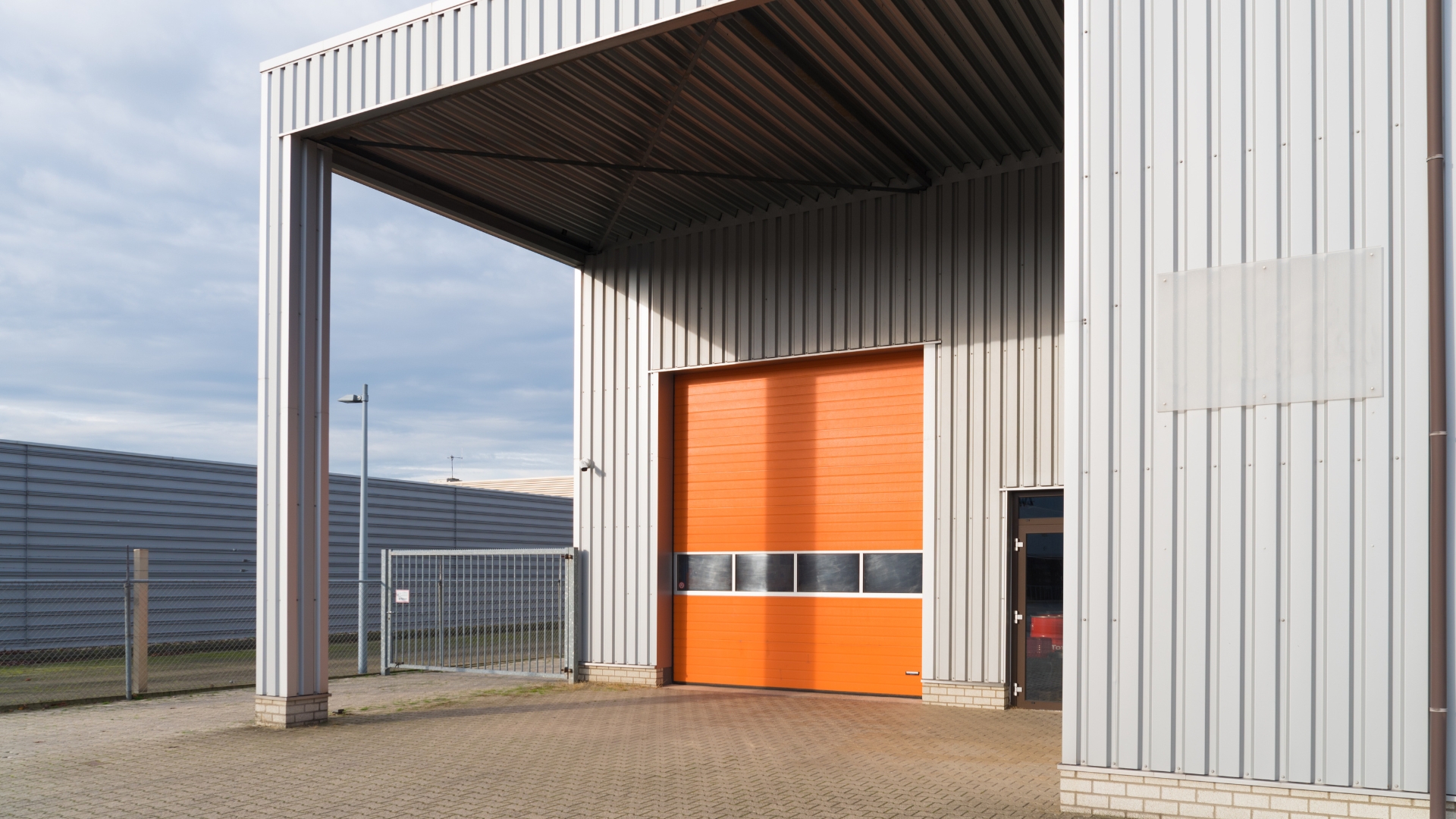 An industrial garage door with customized color and windows