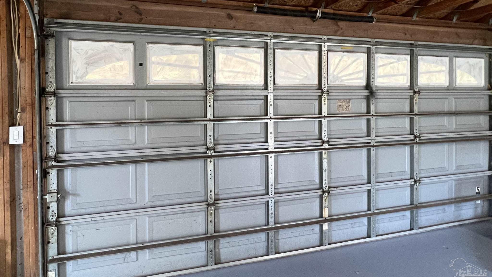 A hurricane-rated garage door with reinforcement brackets