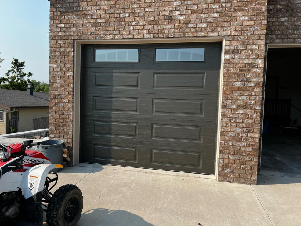 Custom garage door installation showing new door panels