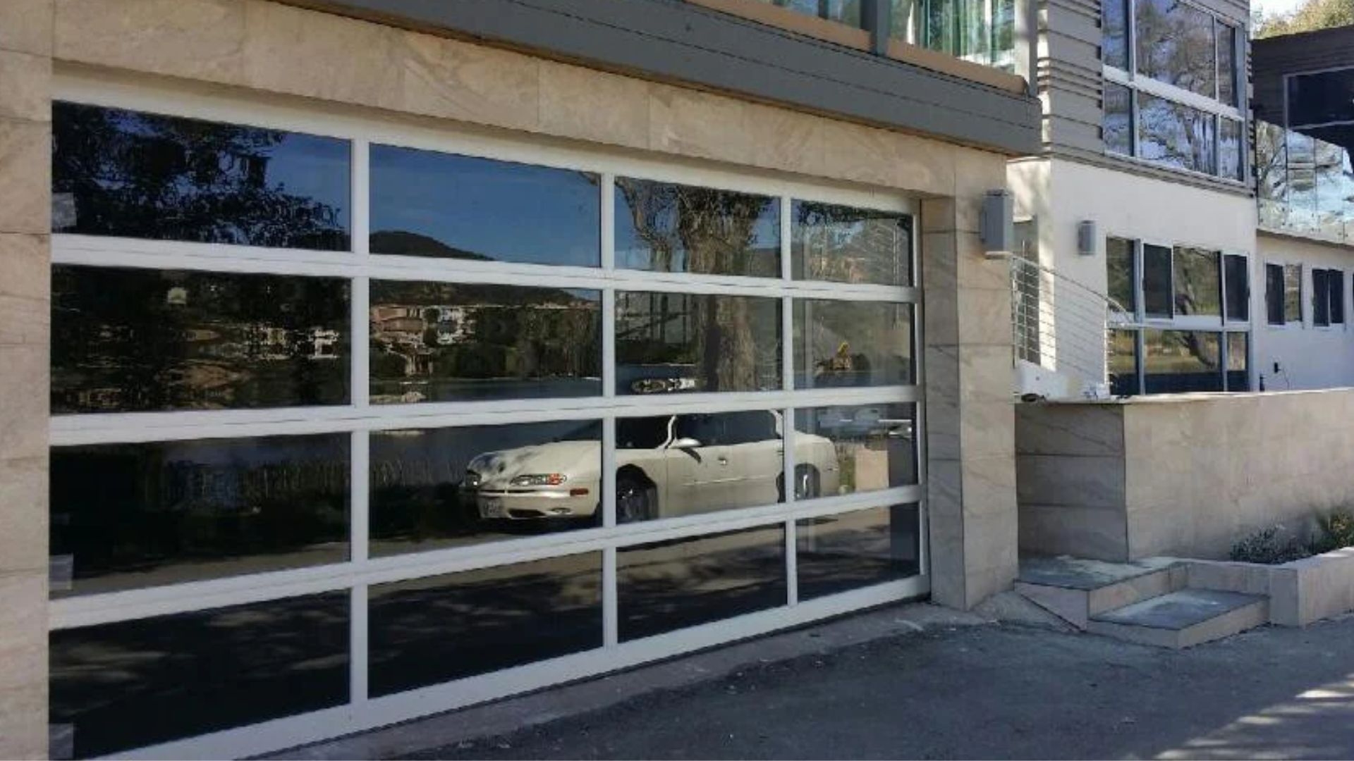 Insulated glass garage doors with steel frames