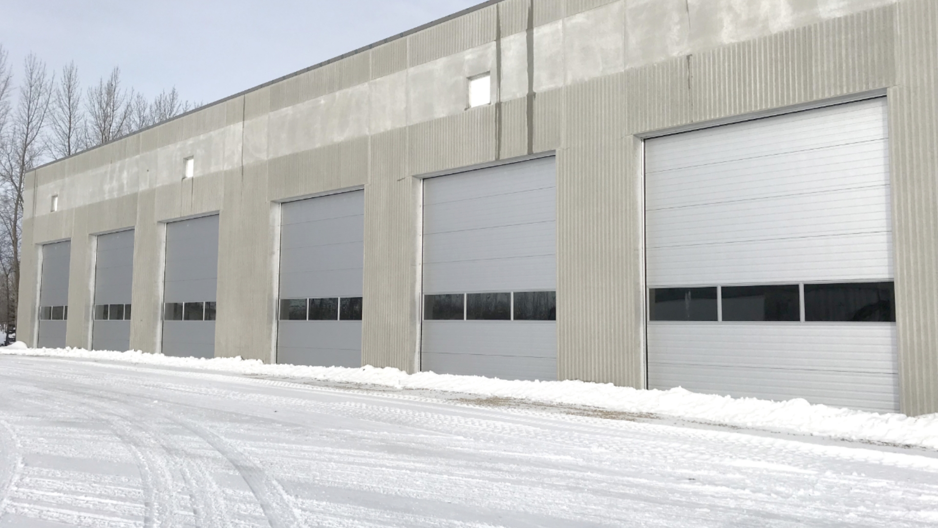 A warehouse with multiple commercial sectional doors