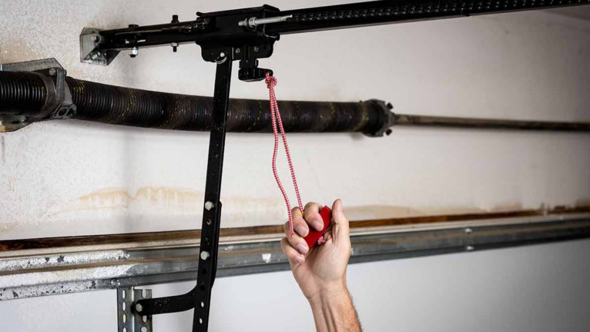 Pulling the red cord to reattach garage door opener