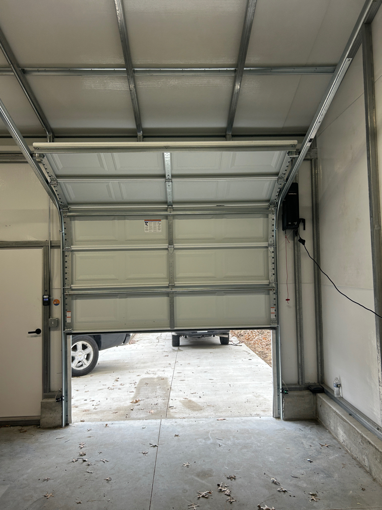 Garage door won't open, leaving the commercial entrance partially open.