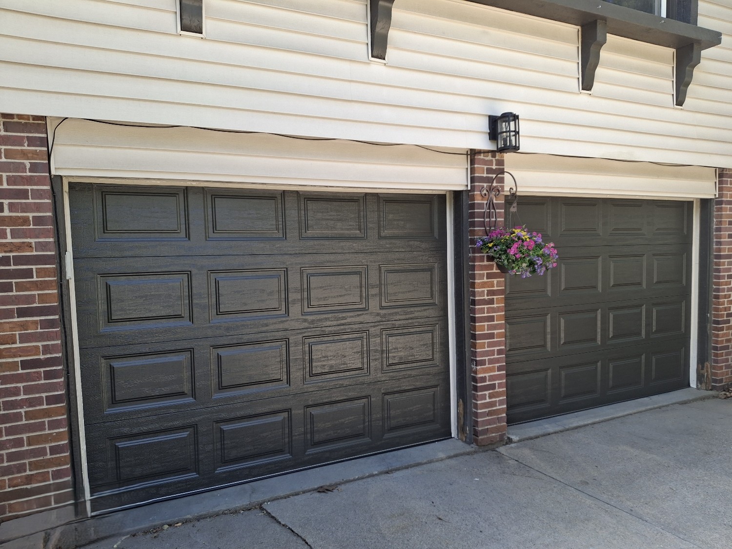 Custom garage door installation showing new door panels and hardware