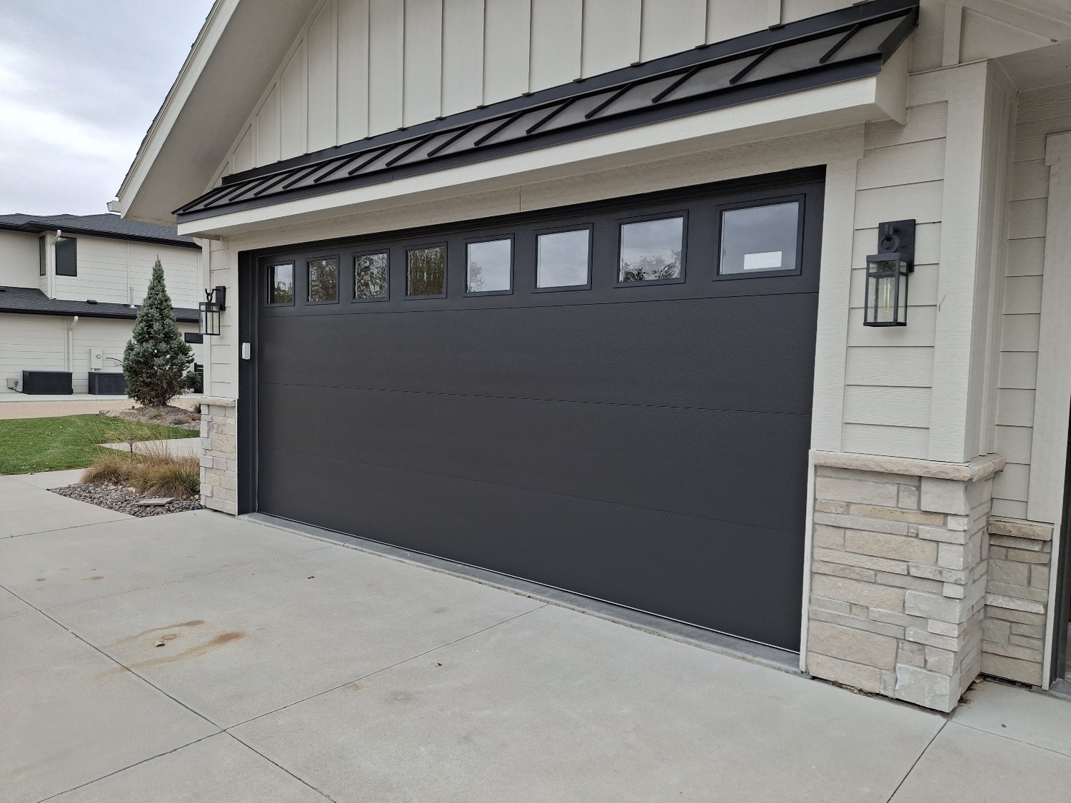 Custom garage door installation with sectional door panels