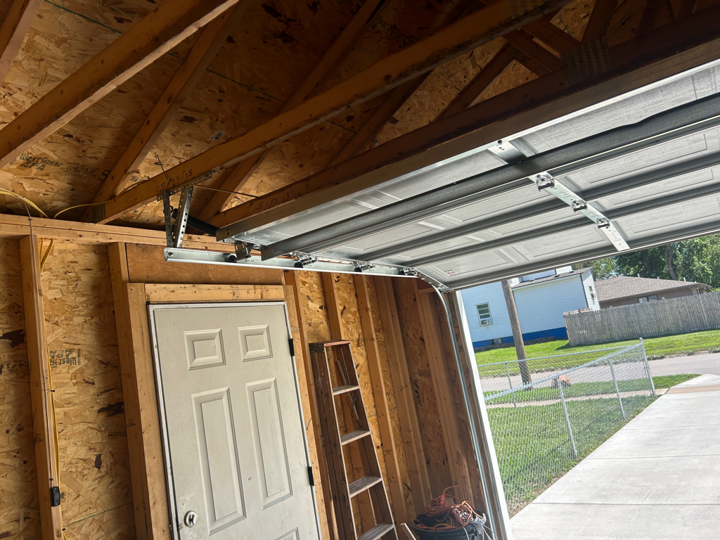 Garage door tune-up for a residential sectional garage door and track system