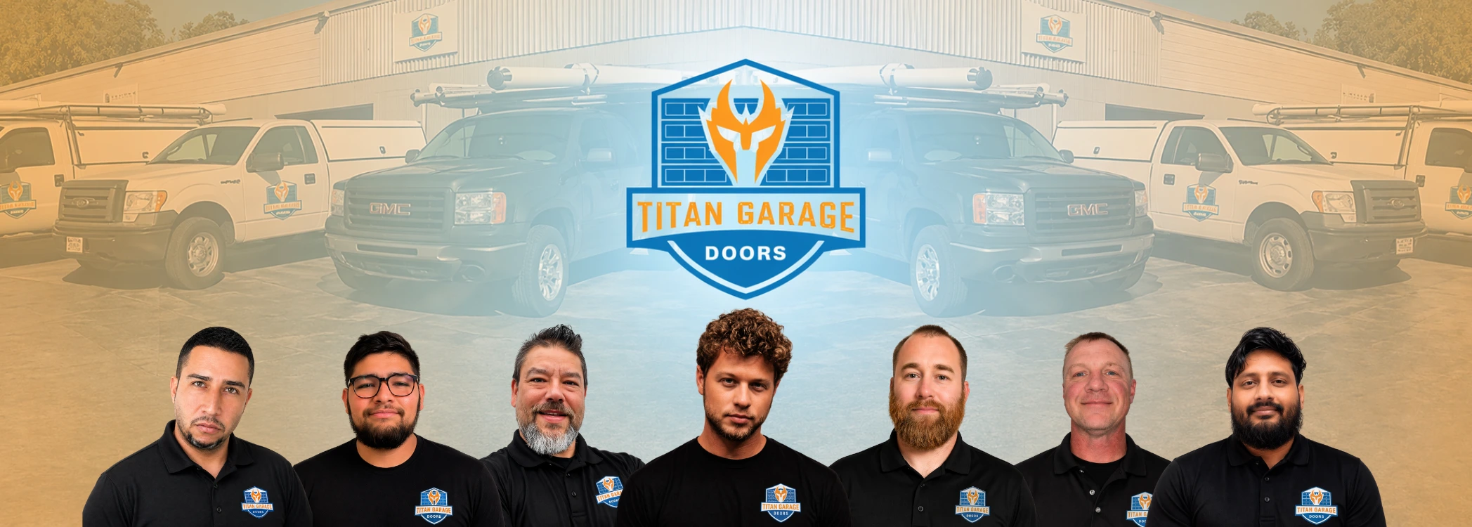 Team of professional garage door technicians from Titan Garage Doors NE standing in front of branded service trucks and warehouse building.